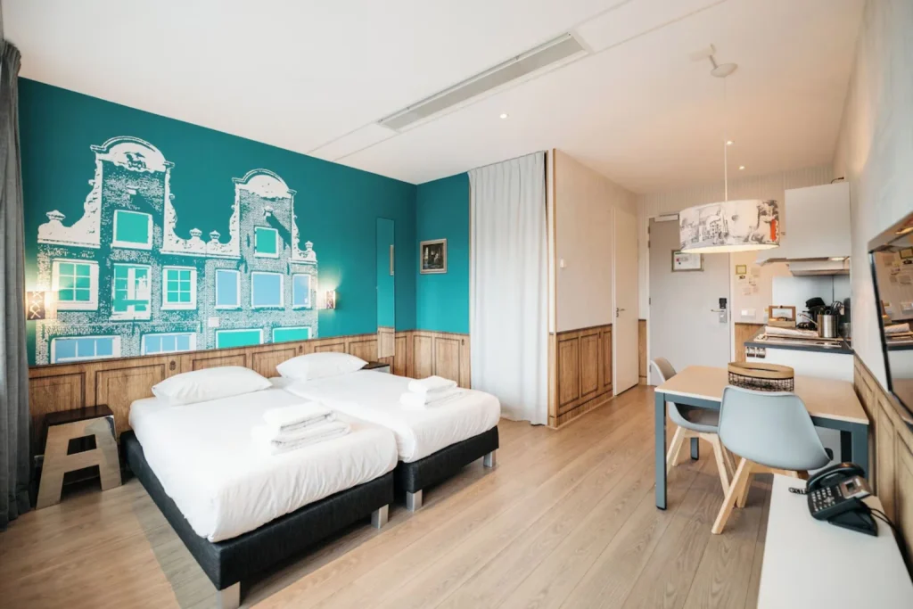 Bright studio apartment with twin beds, a private kitchenette and dining space at Amsterdam ID Aparthotel, Amsterdam.
