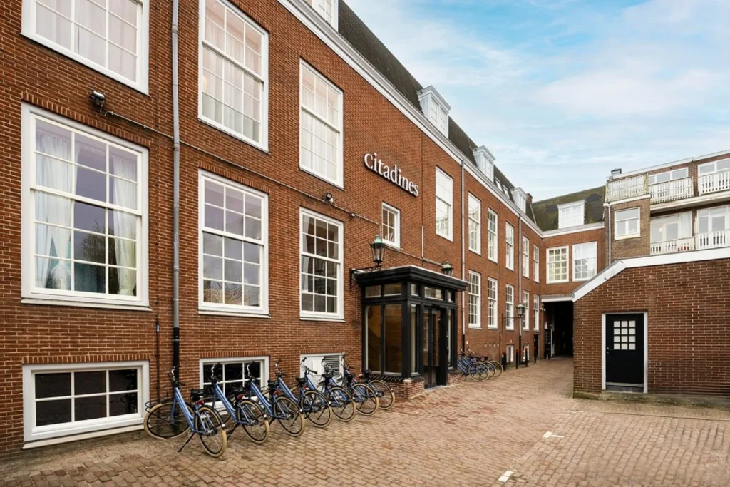 Historic brick façade and entrance of Citadines Canal Amsterdam