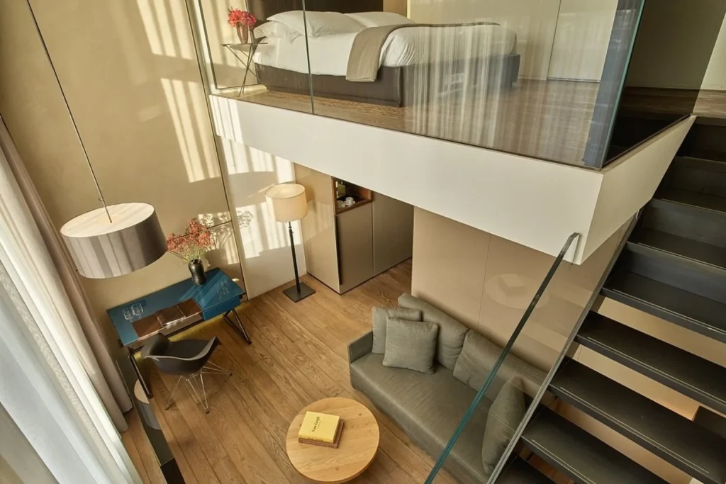 Duplex suite with an upper-level bedroom and living area at Conservatorium Hotel in Amsterdam