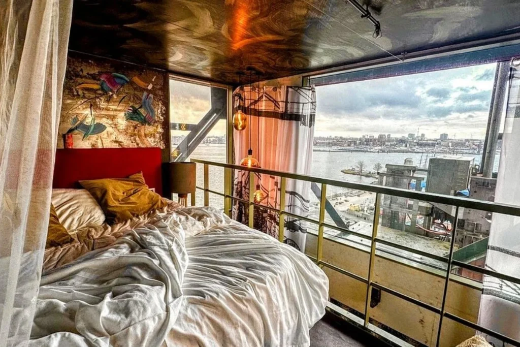 Unique room with artistic decor and panoramic waterfront views at Crane Hotel Faralda Amsterdam