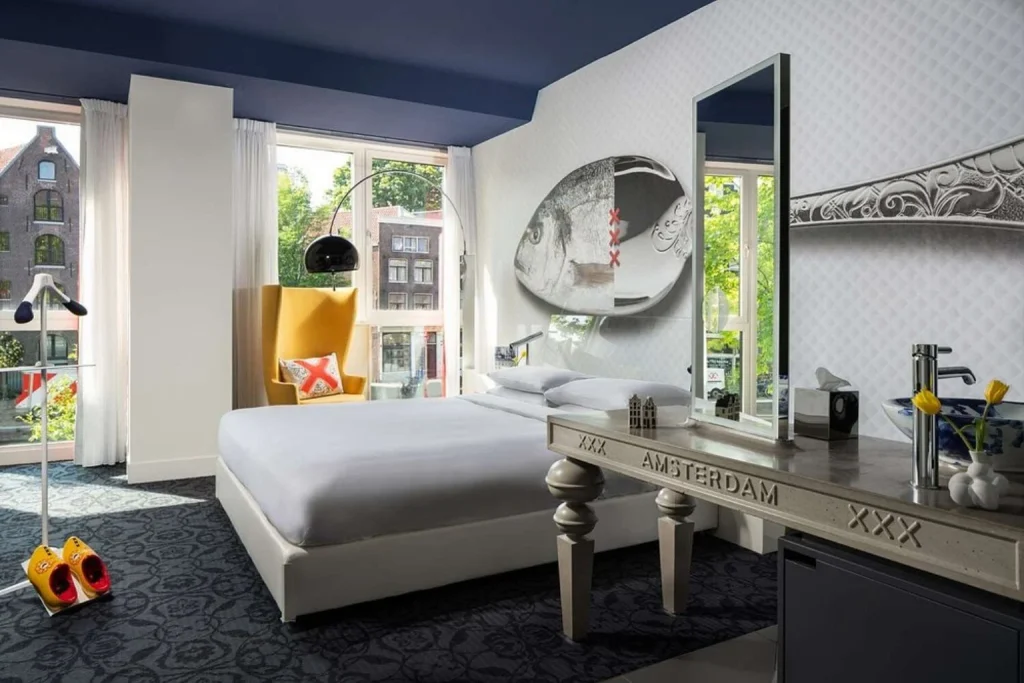 Designer hotel room with modern decor, large windows and distinctive artwork at Andaz Prinsengracht by Hyatt, Amsterdam