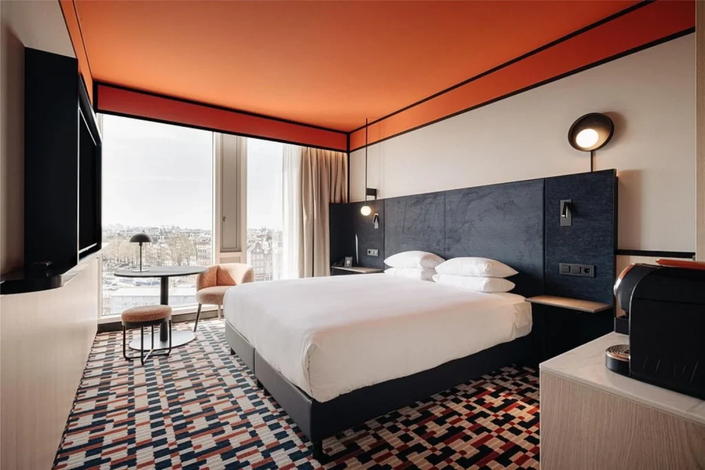 Modern guest room with city view at DoubleTree by Hilton Amsterdam Centraal Station in Amsterdam, Netherlands