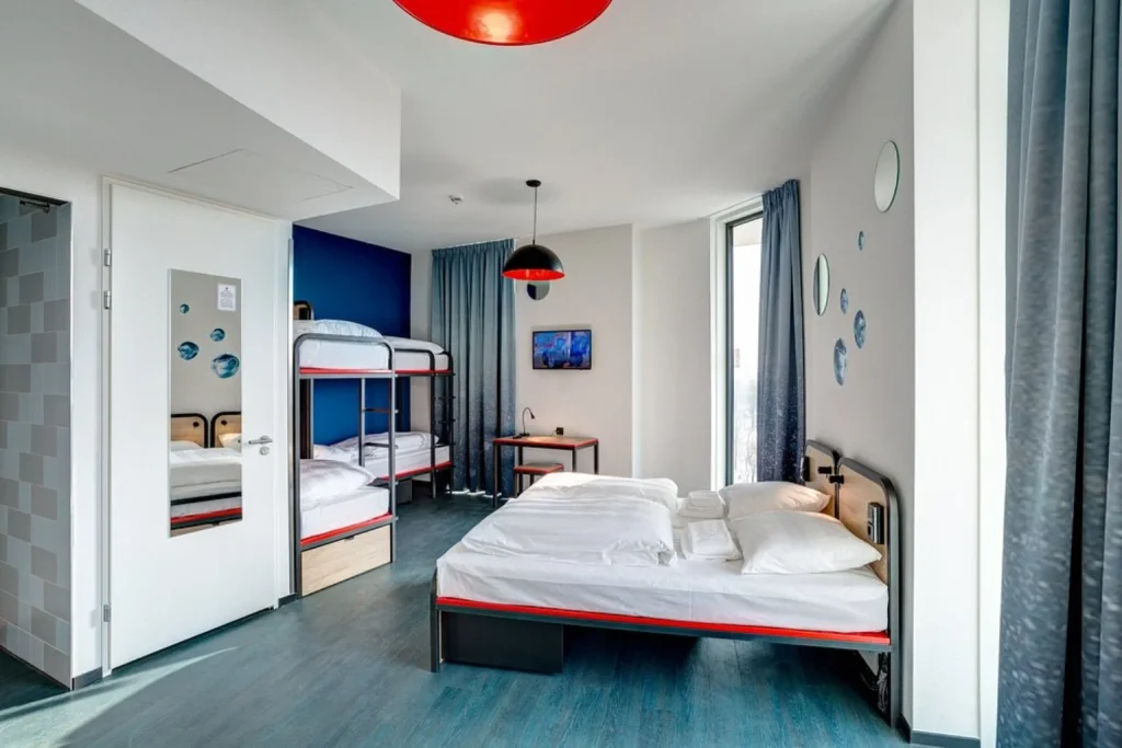 Modern family room with double bed and bunk beds at MEININGER Hotel Amsterdam Amstel, Amsterdam