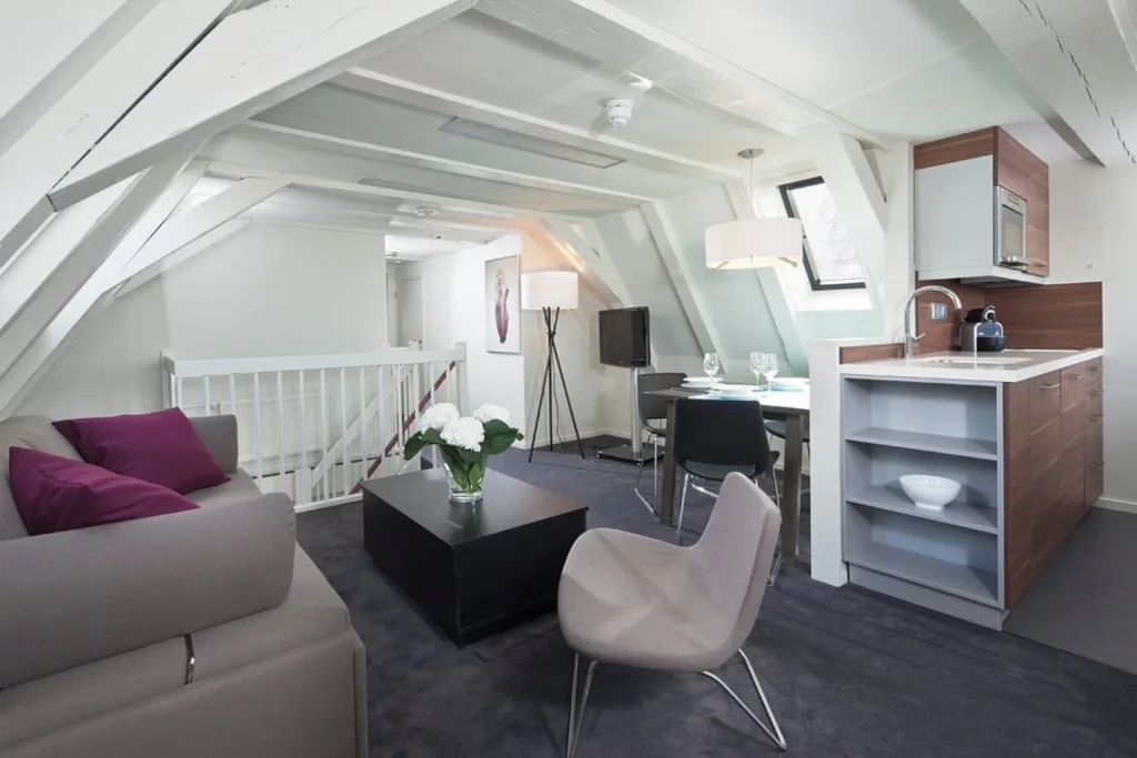 Duplex apartment with living room, kitchenette, dining area and exposed wooden beams at Hapimag Apartments Amsterdam, Amsterdam
