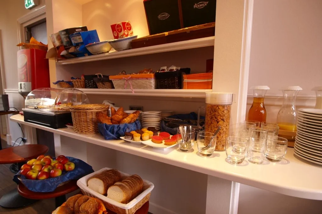 Continental breakfast buffet with fresh croissants, breads, fruit, cereals and juices at Hotel Clemens Amsterdam, Amsterdam.
