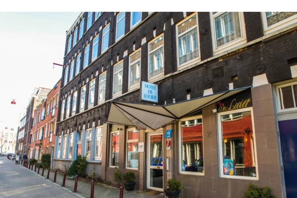 Hotel entrance with a street-facing facade at Hotel De Looier in Amsterdam.