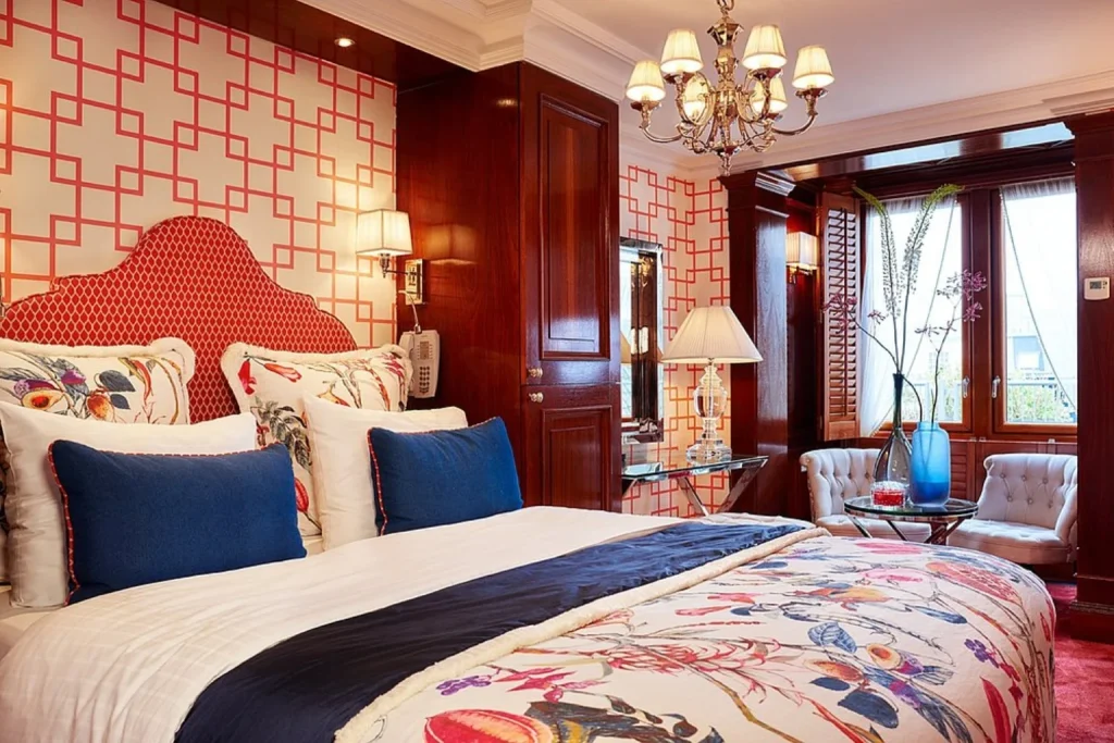 Luxury bedroom with floral bedding and elegant furnishings at Hotel Estherea in Amsterdam