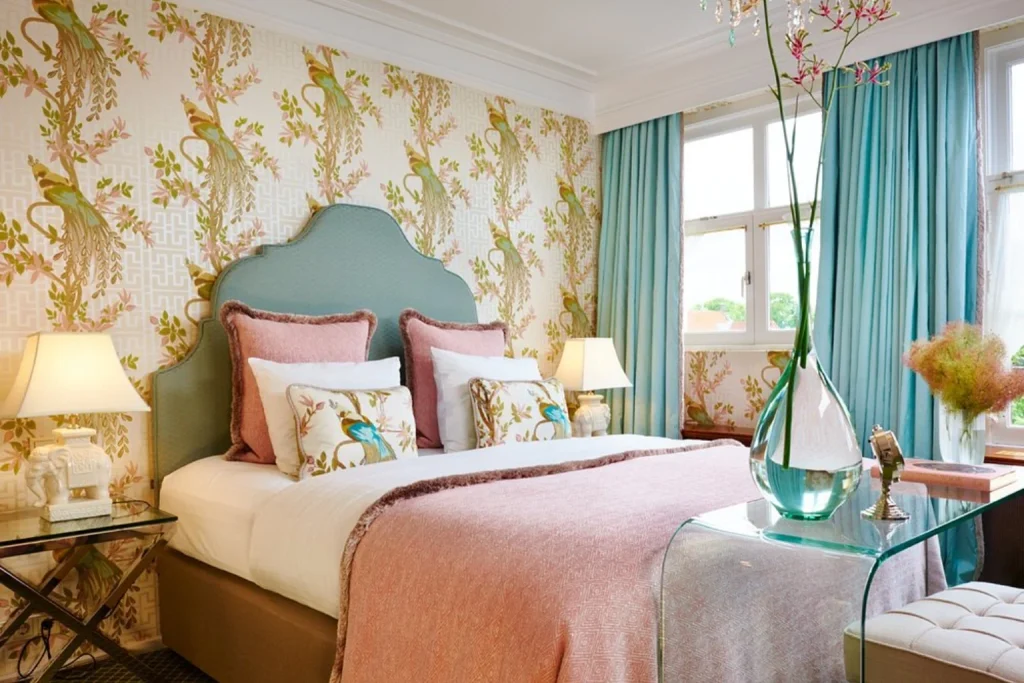 Colorful guest room at Hotel Estherea Amsterdam with floral wallpaper and classic boutique-style décor