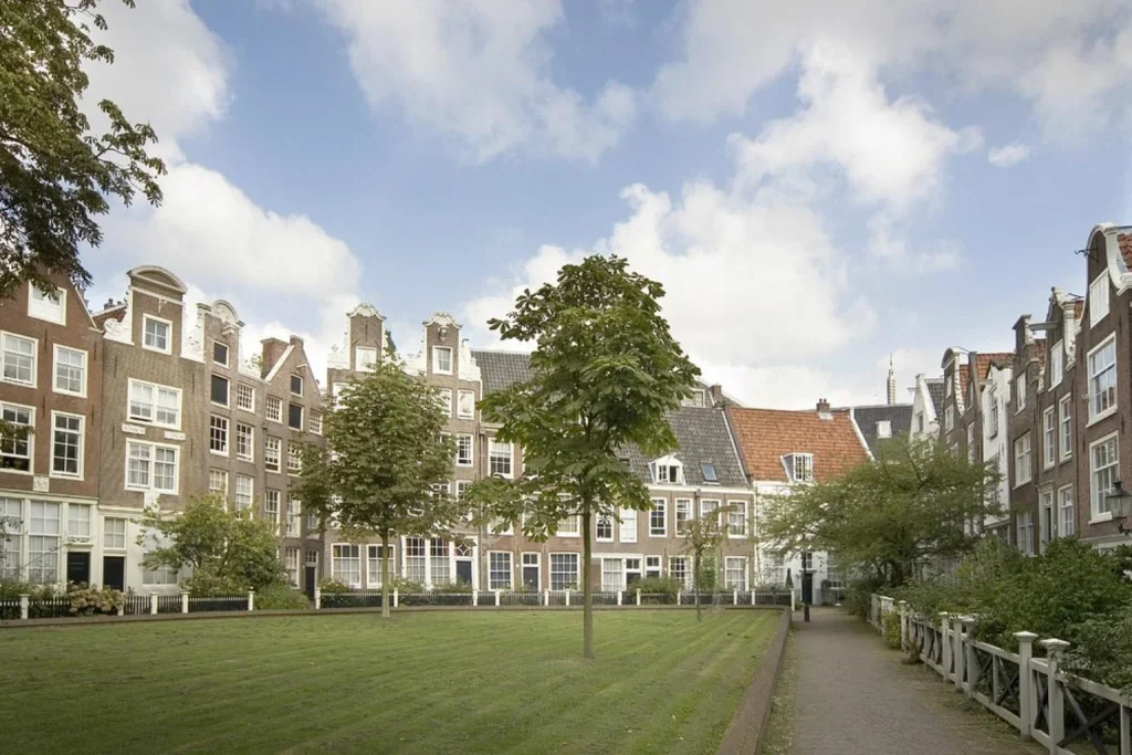 Peaceful courtyard garden surrounded by traditional Dutch houses near Hotel Nova Amsterdam