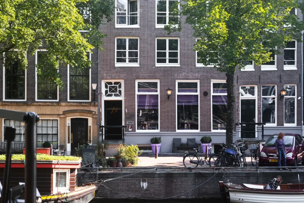 Charming canal-side setting with historic Dutch façades and bicycles at Hotel Sebastian's Amsterdam.