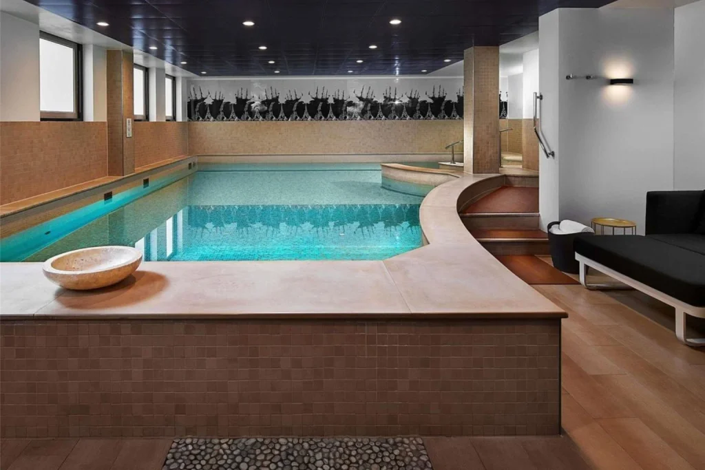 Indoor swimming pool with spa lounge area and contemporary design at Sofitel Legend The Grand, Amsterdam