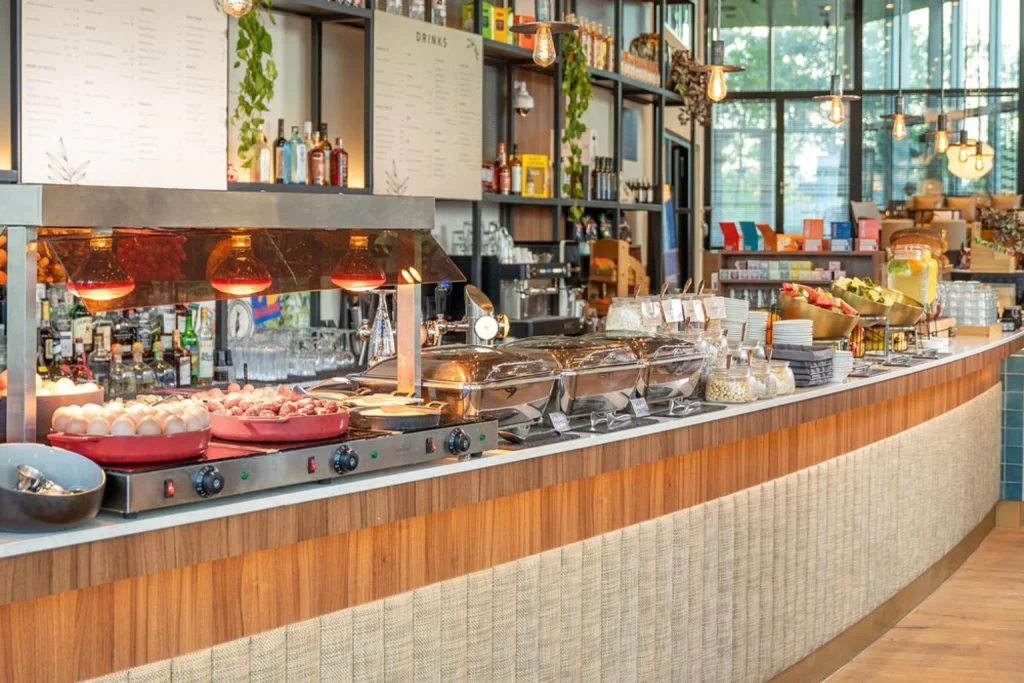 Generous breakfast buffet with hot dishes, fresh fruit, cereals and drinks at INNSiDE by Meliá Amsterdam.