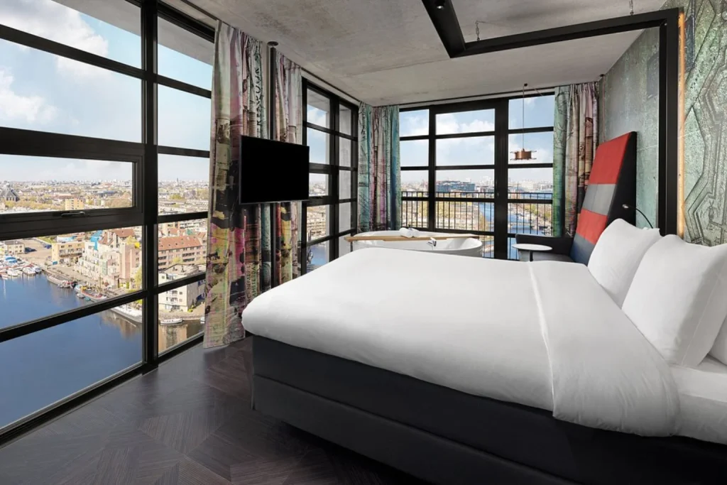 Wellness suite with whirlpool bathtub and panoramic city views at Inntel Hotels Amsterdam Landmark