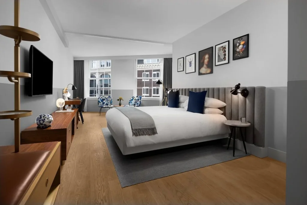 Spacious king room with a sitting area and modern furnishings at Kimpton De Witt Amsterdam