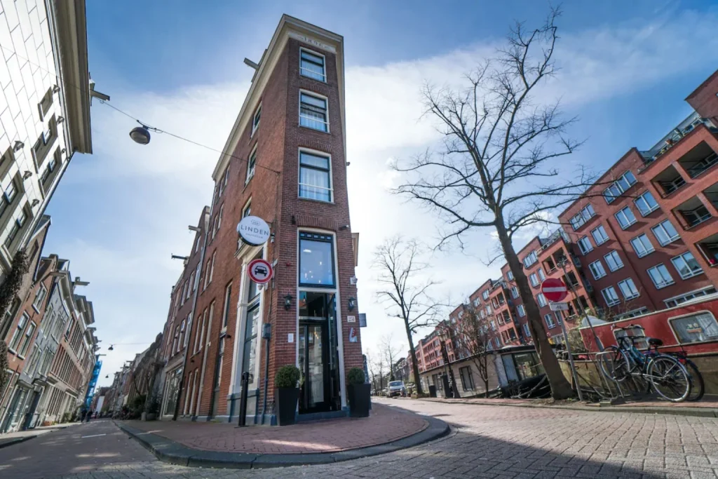 Exterior of Linden Hotel on a street corner in Amsterdam