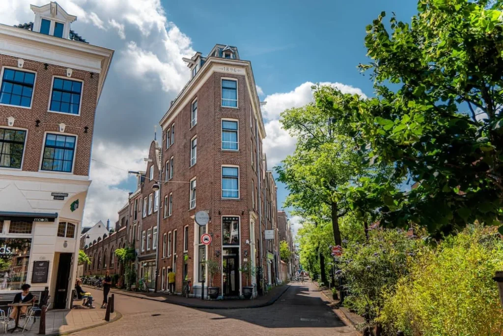 Historic brick hotel building on a corner street at Linden Hotel in Amsterdam.
