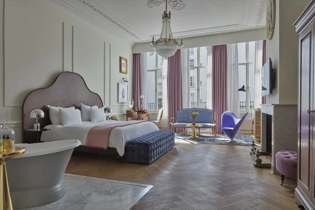 Luxury suite with freestanding bathtub, chandelier and elegant sitting area at Pulitzer Amsterdam, Amsterdam