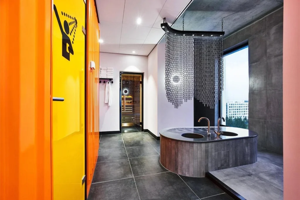 Modern spa bathroom with freestanding tub, rainfall shower and sauna at Jaz in the City, Amsterdam