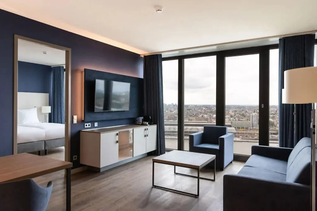 Modern suite with floor-to-ceiling windows and panoramic city views at Maritim Hotel Amsterdam Noord, Amsterdam