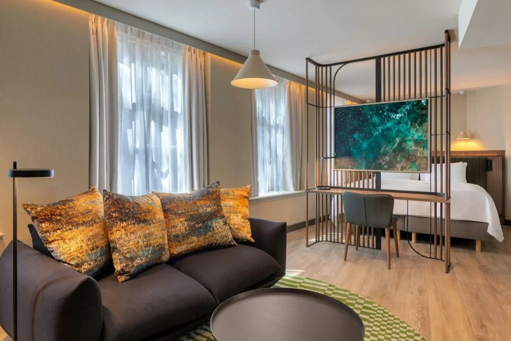 Modern suite with sofa, workspace and contemporary open-plan design at Renaissance Amsterdam Hotel, Amsterdam
