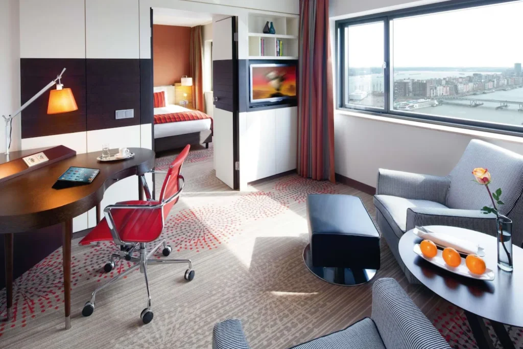 Suite living area with waterfront view at Mövenpick Hotel Amsterdam City Centre