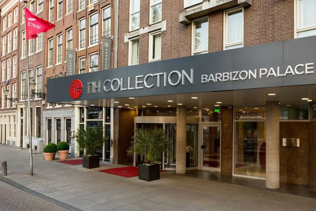 Main entrance set within historic brick buildings in the city centre, NH Collection Amsterdam Barbizon Palace, Amsterdam
