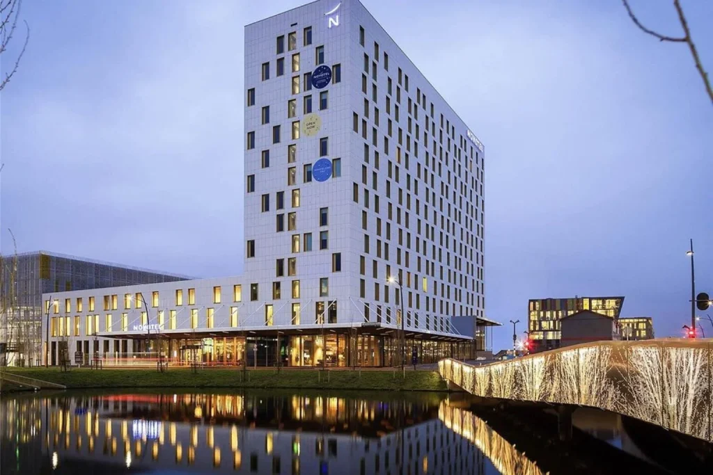Exterior with pond reflection at Novotel Amsterdam Schiphol Airport in Hoofddorp, Netherlands