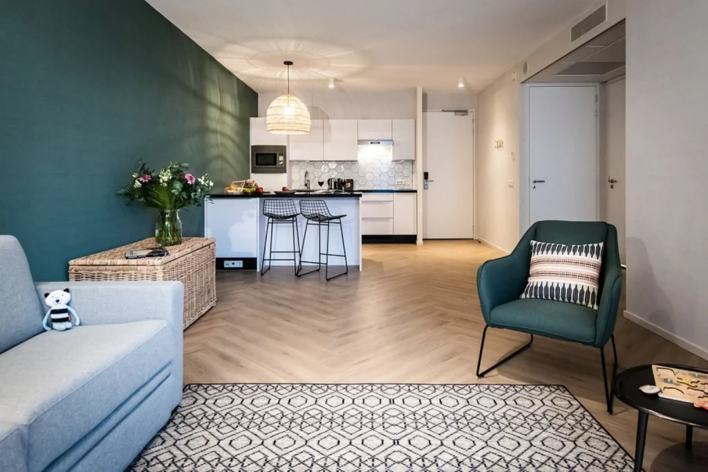 Spacious apartment at Numa Amsterdam Docklands featuring a modern kitchen, breakfast bar and comfortable living area