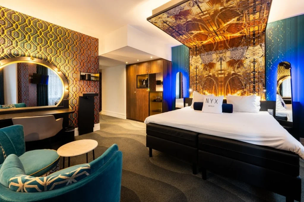 Stylish guest room at NYX Hotel Amsterdam Rembrandt Square featuring bold artwork and contemporary design