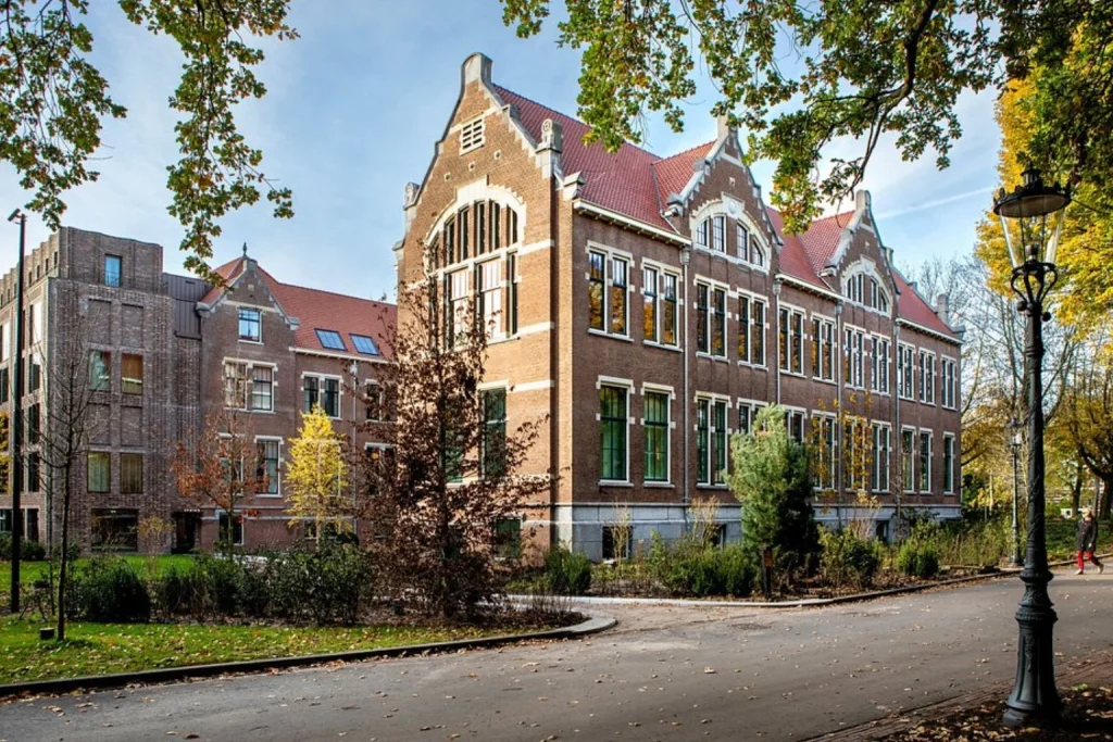 Historic brick hotel building surrounded by mature trees beside Oosterpark, Pillows Grand Boutique Hotel Maurits at the Park, Amsterdam