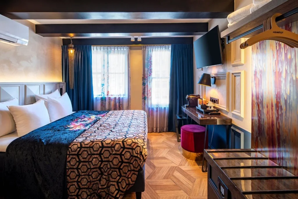 Stylish double room with patterned bedding and colorful décor at Rokin Hotel in Amsterdam