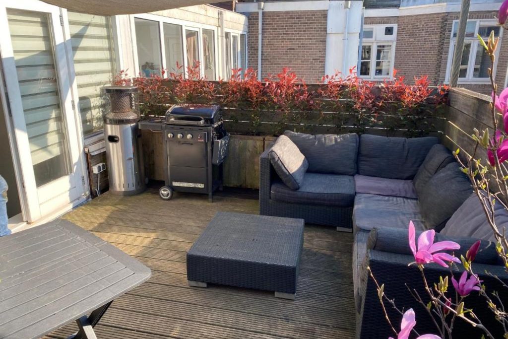 Private rooftop terrace with outdoor seating and barbecue at Rooftop Terrace Apartment Amsterdam