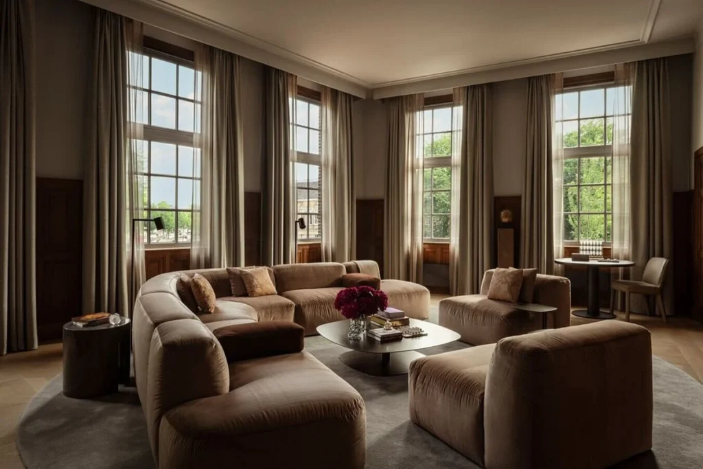 Elegant lounge with large windows and plush seating at Rosewood Amsterdam, Amsterdam