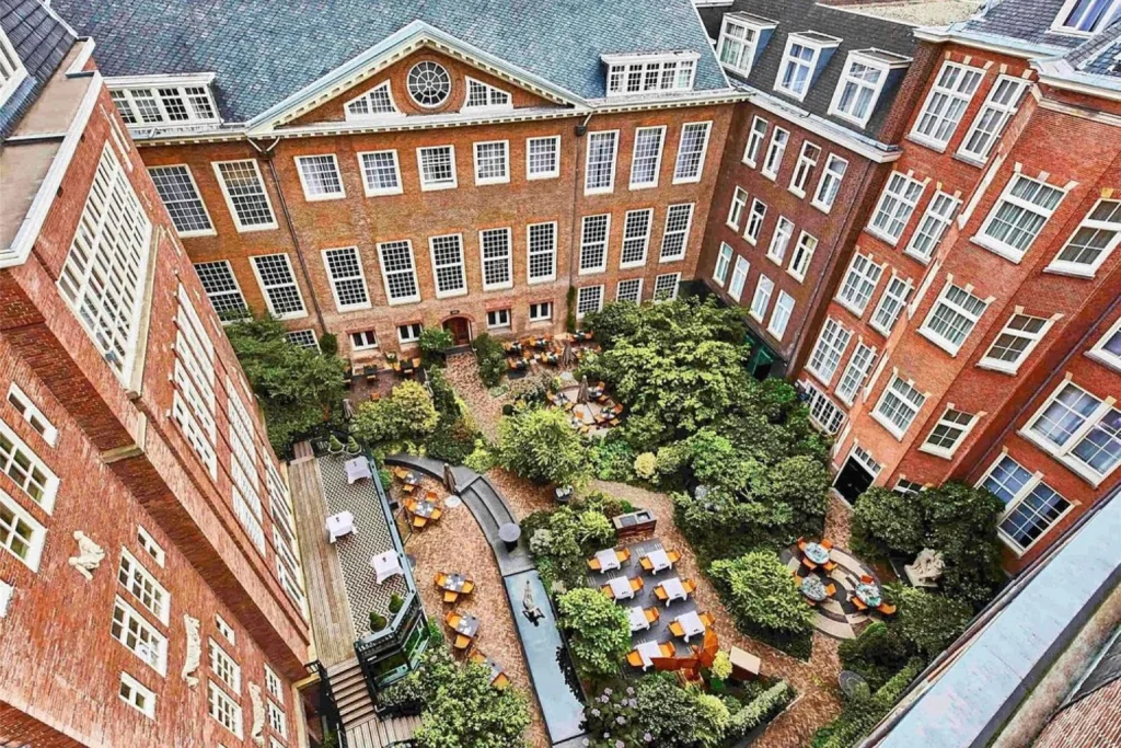 Historic courtyard surrounded by red-brick buildings at The Grand Amsterdam