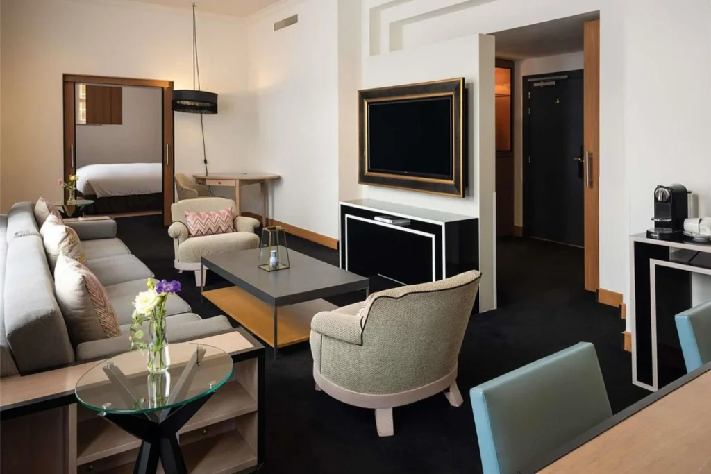 Elegant suite at Sofitel Legend The Grand Amsterdam featuring a spacious separate living area, refined seating and sophisticated contemporary décor.