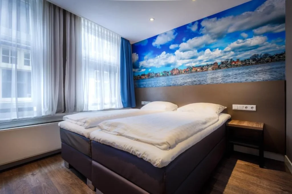 Twin bedroom featuring a waterfront mural at The Old Nickel Hotel in Amsterdam