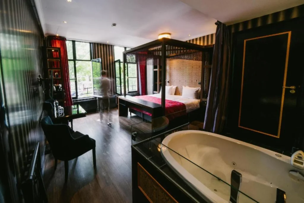 Luxurious Royal Suite with a four-poster bed, private whirlpool bathtub and canal views at The Pavilions Amsterdam, The Toren.