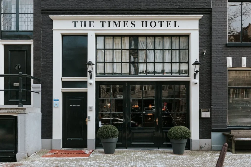 Elegant black-brick façade and street-level entrance in central Amsterdam at The Times Hotel Amsterdam.