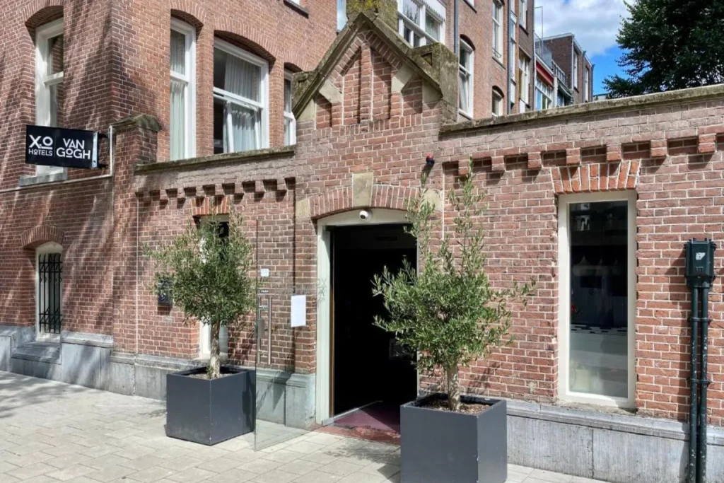 Brick façade and main entrance of XO Hotel Van Gogh in Amsterdam, Netherlands.