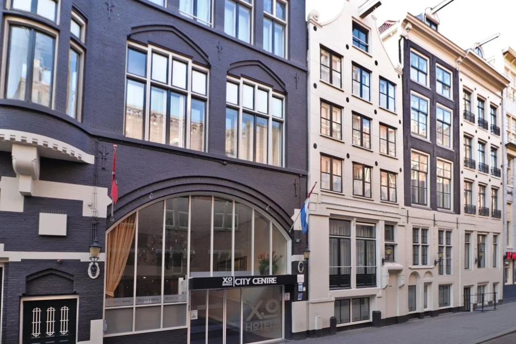 Historic Dutch architecture surrounding the entrance of XO Hotels City Centre, Amsterdam, Netherlands