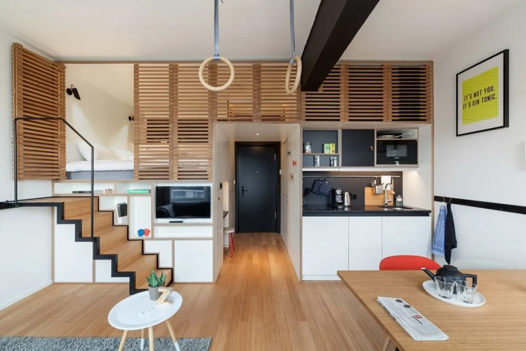 Modern loft apartment with raised bed, kitchenette and dining area at Zoku Amsterdam, Amsterdam