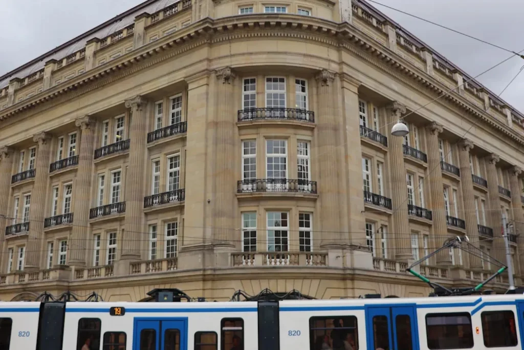 Grand historic architecture and a passing city tram in the lively Leidseplein district near Amsterdam Hostel Leidseplein, Amsterdam, Netherlands