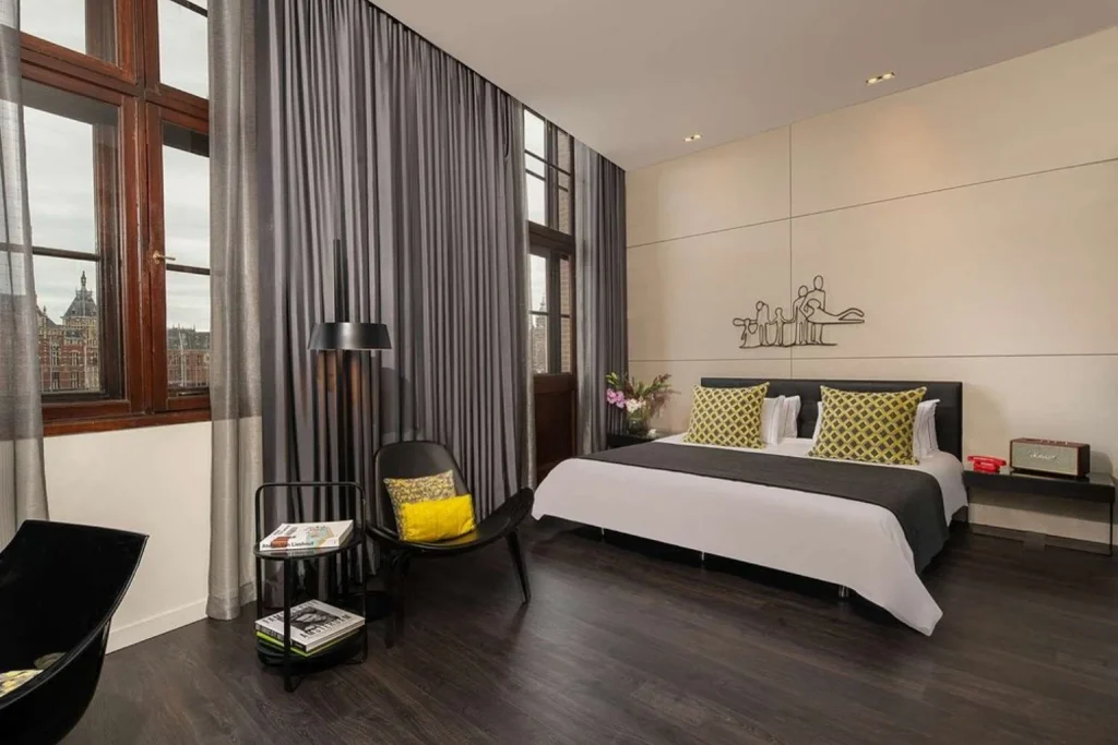 Contemporary guest room with artistic details, large windows and modern furnishings at art’otel Amsterdam, Amsterdam, Netherlands
