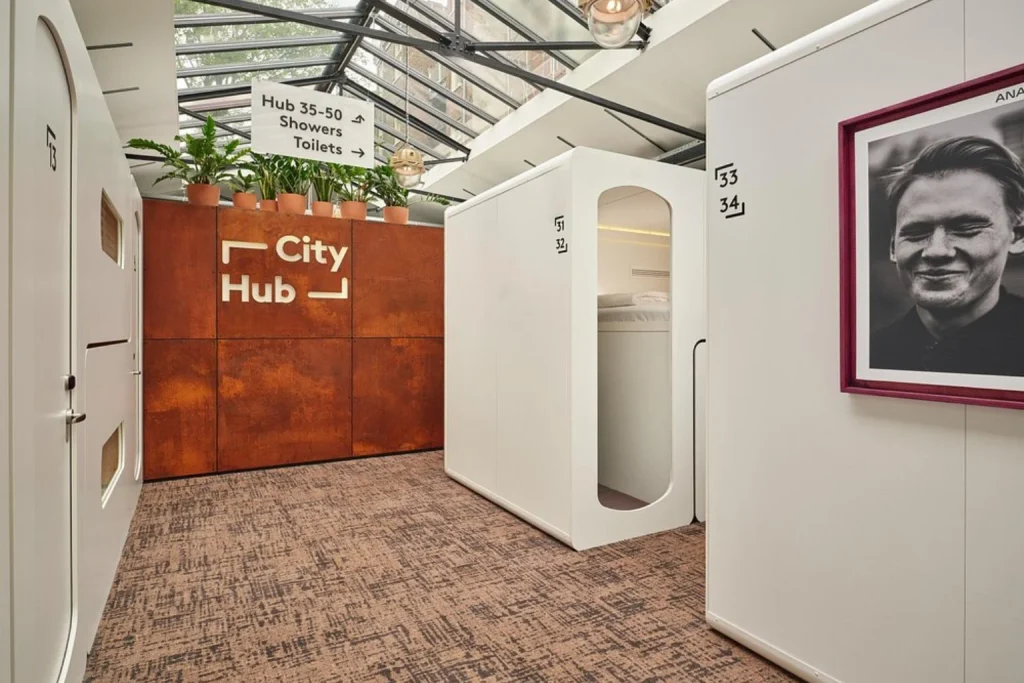 Modern sleeping pods and glass-roofed interior at CityHub Amsterdam, Amsterdam, Netherlands