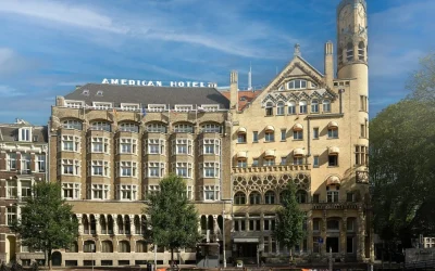 Grand historic hotel exterior with ornate architecture, arched windows and a landmark corner tower at Clayton Hotel Amsterdam American, Amsterdam