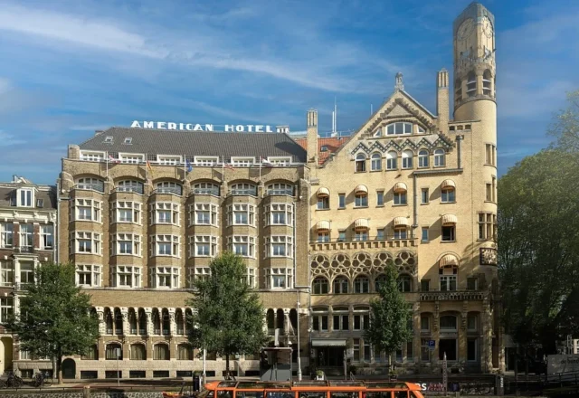 Grand historic hotel exterior with ornate architecture, arched windows and a landmark corner tower at Clayton Hotel Amsterdam American, Amsterdam