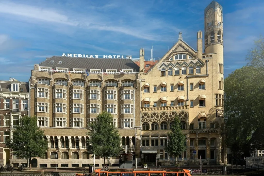 Grand historic hotel exterior with ornate architecture, arched windows and a landmark corner tower at Clayton Hotel Amsterdam American, Amsterdam