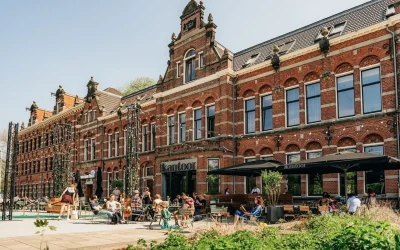 Historic brick hotel building with outdoor terrace and greenery at Conscious Hotel Westerpark, Amsterdam