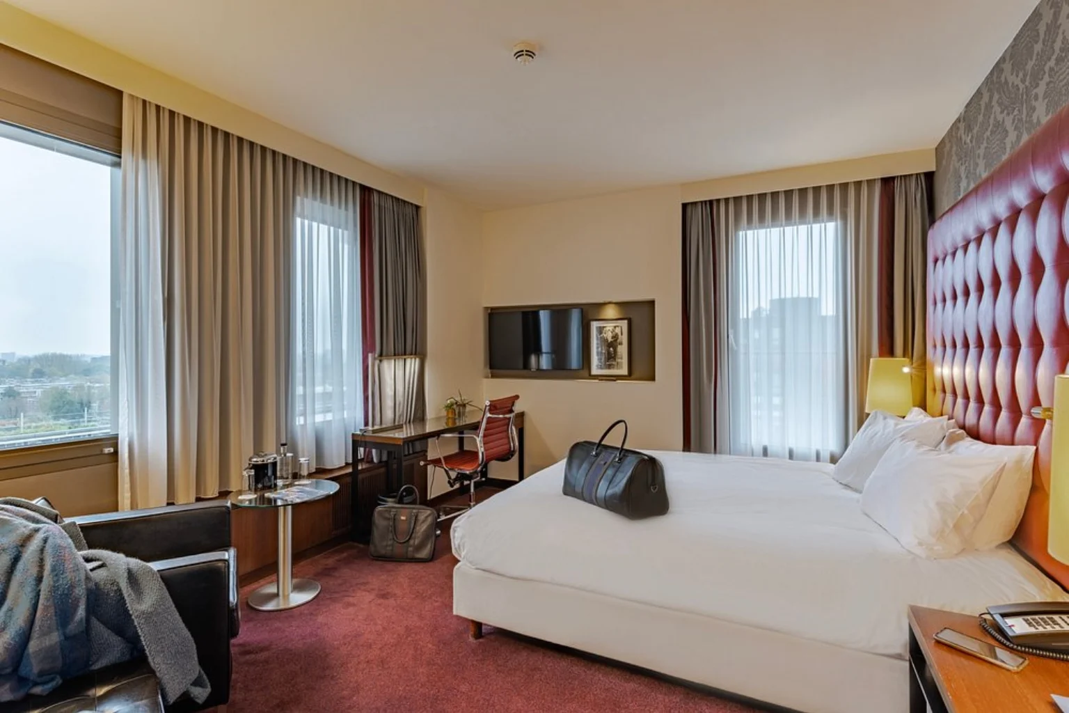Spacious modern hotel room with king-size bed and large windows at Crowne Plaza Amsterdam – South, Amsterdam