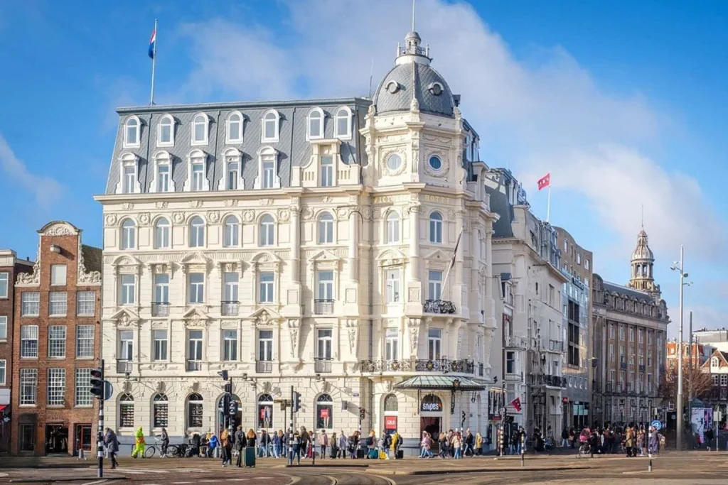 Ornate landmark façade overlooking a busy street near Amsterdam Central Station, Park Plaza Victoria Amsterdam